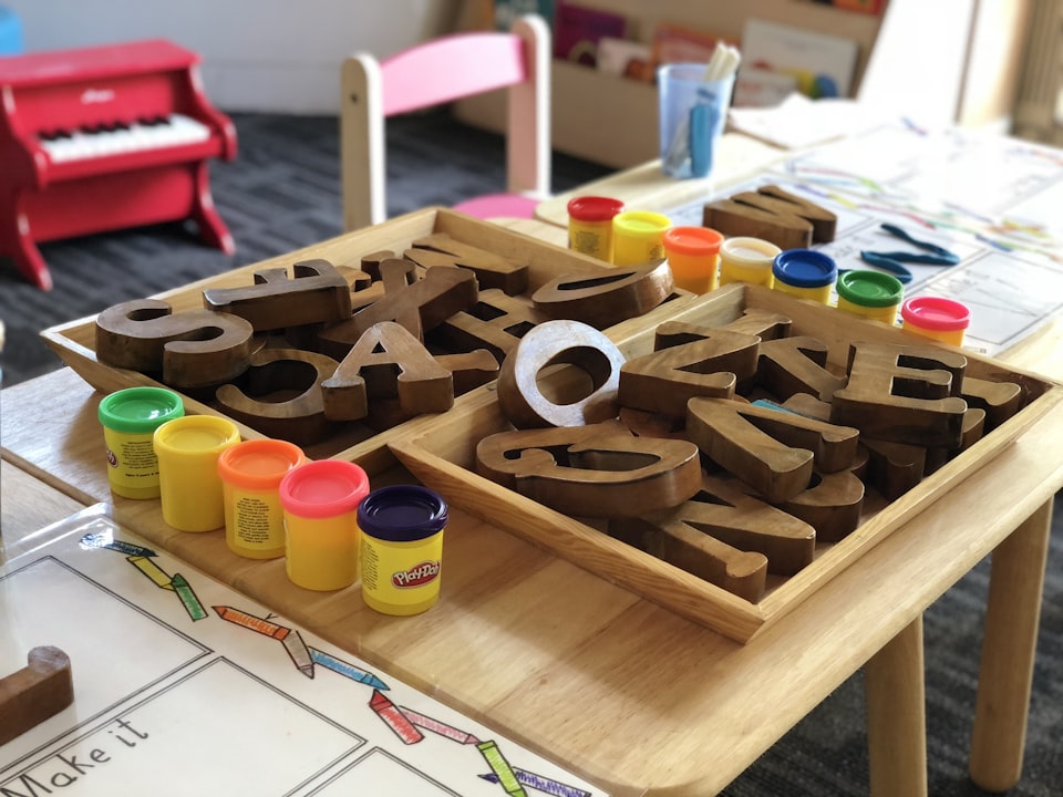 Wooden letters and clay tubs on a play table